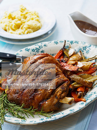 Roast shoulder of lamb with vegetables, rosemary, mashed potatoes and gravy