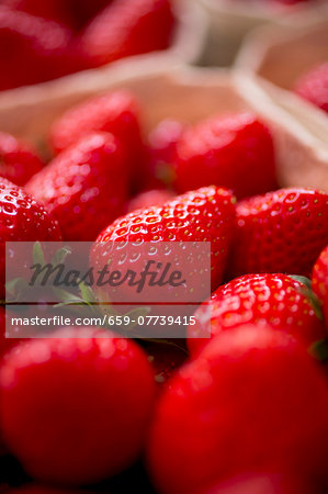 Fresh strawberries in a paper punnet (close-up)