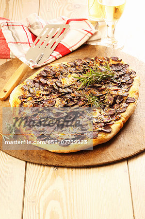 A sausage and rosemary pizza