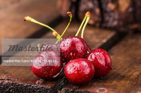 Freshly washed cherries on a wooden crate