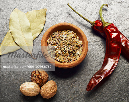 Fennel seeds, bay leaves, nutmeg and dried chilli peppers Fennel seeds, bay leaves, nutmeg and dried chilli peppers