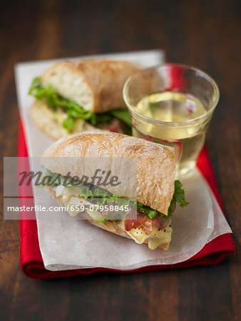 A sandwich made with brie, avocado and bacon A sandwich made with brie, avocado and bacon