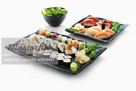 Two sushi platters with wasabi and ginger Two sushi platters with wasabi and ginger