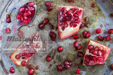 Sliced pomegranate on a silver tray