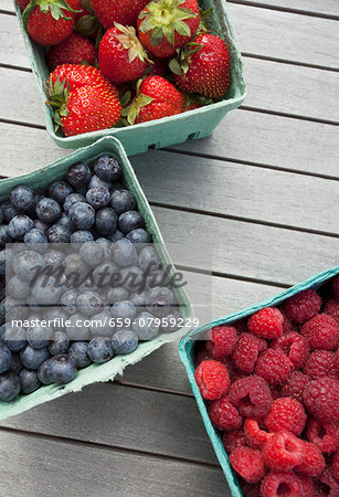 Fresh berries in green paper punnets Fresh berries in green paper punnets