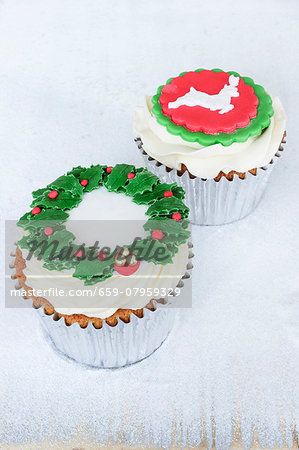 Lemon and chocolate cupcakes decorated with a wreath of holly and a reindeer Lemon and chocolate cupcakes decorated with a wreath of holly and a reindeer