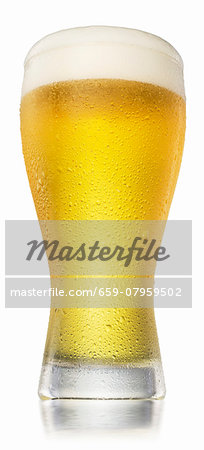 A full glass of beer with water droplets and a head of foam A full glass of beer with water droplets and a head of foam
