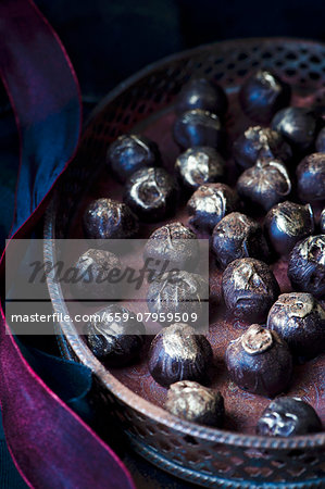 Homemade dark chocolate truffle sprinkled with edible gold powder