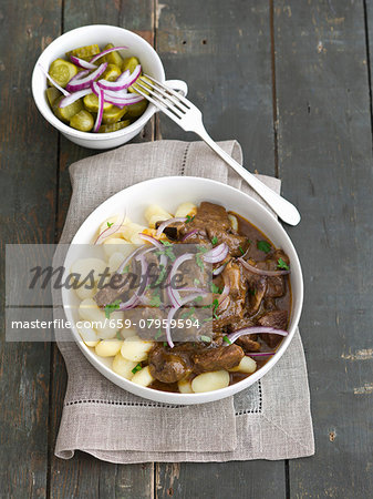 Beef goulash with red-capped scaber stalks and bay boletes on a bed of potatoes