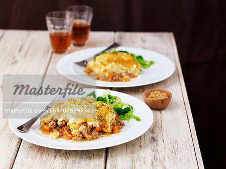 Two large portions of shepherd's pie with beer Two large portions of shepherd's pie with beer