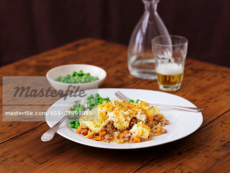 A portion of shepherd's pie with peas A portion of shepherd's pie with peas