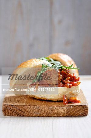 A turkey meatball sandwich with a tomato and onion sauce A turkey meatball sandwich with a tomato and onion sauce