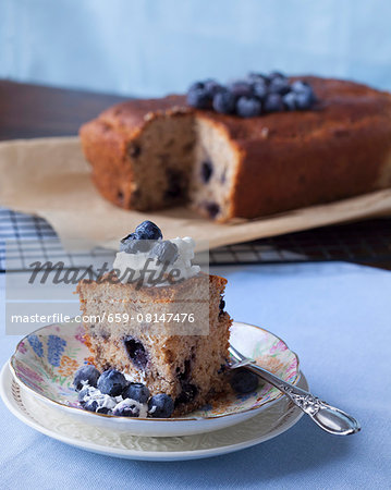A coffee cake with blueberries and whipped cream