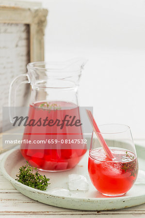 Rhubarb iced tea in a glass and a jug