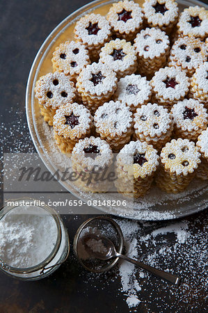 Stacks of jammy shortbread biscuits with icing sugar