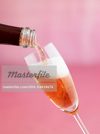 Pouring a glass of rosé sparkling wine