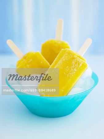 Fruity ice lollies in a bowl of ice