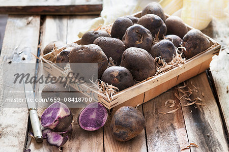 Purple potatoes in a wooden basket