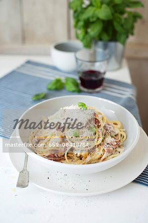 Spaghetti carbonara with fresh basil and Parmesan cheese