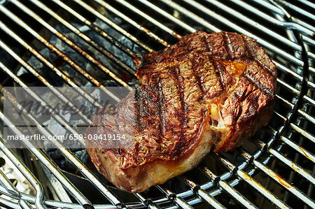 Rib-eye steak on a charcoal grill