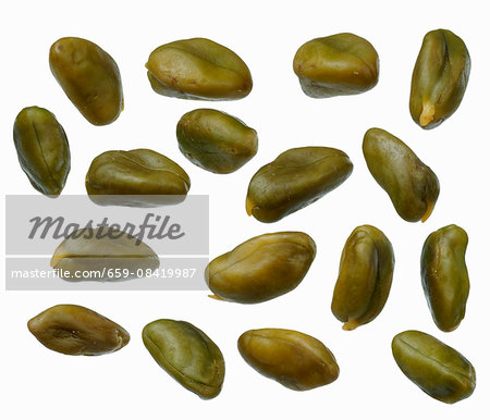 Pistachios on a white surface Pistachios on a white surface
