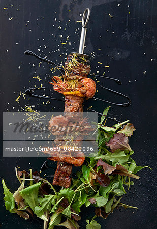 Beef and prawns skewers with salad