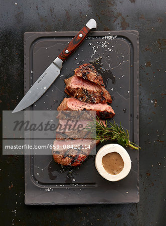 A grilled ribeye steak with sauce A grilled ribeye steak with sauce