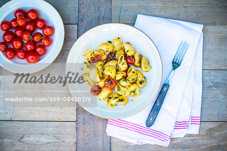 Pasta with fried cherry tomatoes and basil