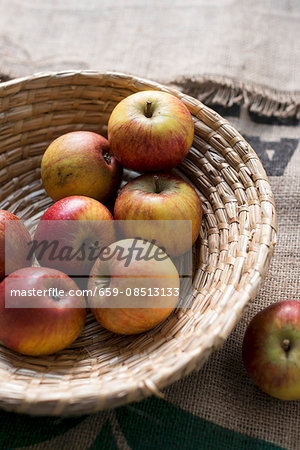 Red and yellow apples in a wicker bowl