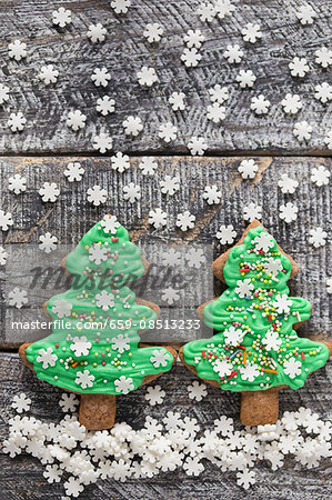 Gingerbread Christmas tree biscuits with green icing and sugar snowflakes