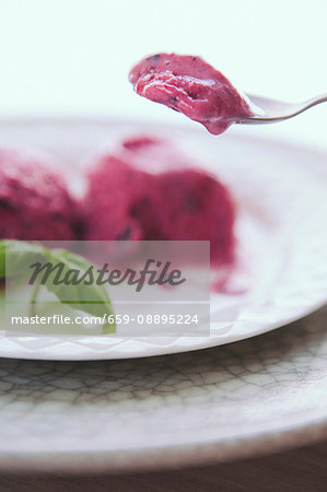 Banana and berry sorbet on a plate and a spoon