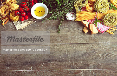 An arrangement of typical Italian food items and family photos on a wooden table