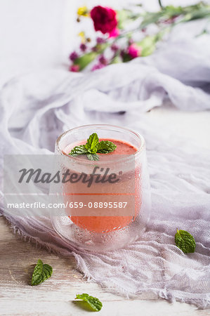 Juice of watermelon and orange and pineapple topped with fresh mint