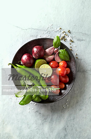 Vegetables, basil and lime for a vegetable dish on a plate Vegetables, basil and lime for a vegetable dish on a plate