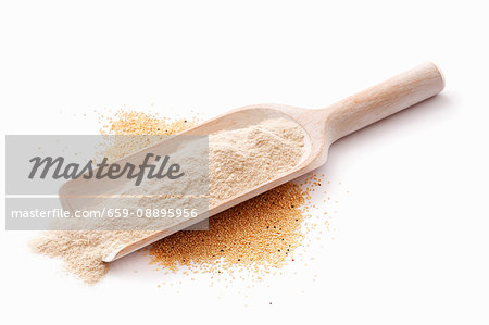 Quinoa flour on a wooden scoop