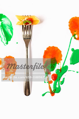 Italian pasta with tomato and basil on fork on white cardboard Italian pasta with tomato and basil on fork on white cardboard
