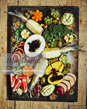 Various fruits on a vintage tray Healthy greens