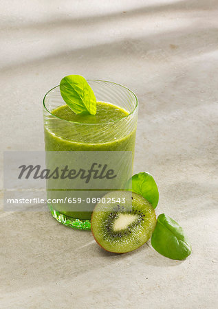 Spinach and kiwi smoothie with almond milk, chia seeds and wheat grass powder