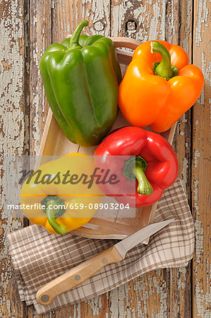 Colourful peppers on a wooden tray