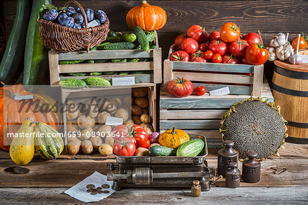 Vegetables and plums at a market