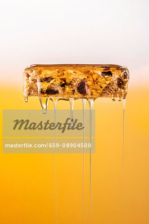 Honey being poured over a muesli bar