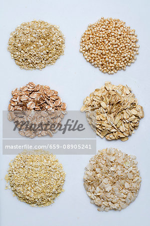 Six piles of various grains on a white surface Six piles of various grains on a white surface