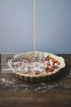 Tomato quiche being made