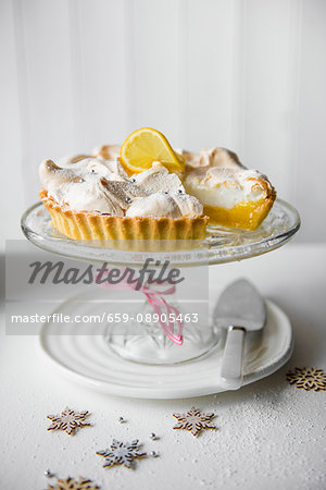 Lemon meringue pie on a glass cake stand for Christmas