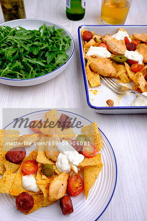 One-pot nachos with chicken, chorizo, jalapeno peppers and cherry tomatoes