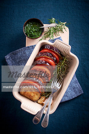 Gratinated aubergines and tomatoes with rosemary and pesto