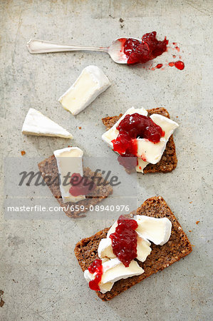 Slices of wholemeal bread topped with Camembert and cranberry jam