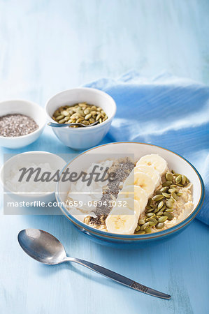 Porridge with bananas, pumpkin seeds, chia seeds and coconut flakes