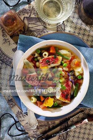 Colourful minestrone with red mullet and edible flowers Colourful minestrone with red mullet and edible flowers