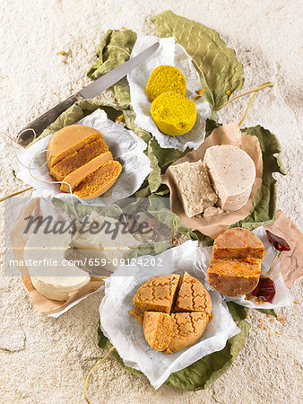 Different types of vegan cheese seasoned with argan oil, curry powder and turmeric